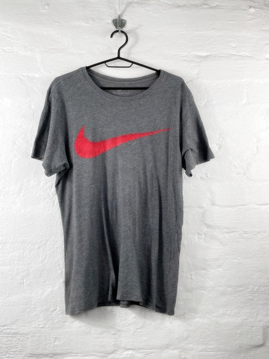 Nike – The Nike Tee with red Swoosh print (approx. late 2010s)